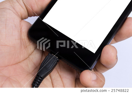 human's hand holding smart phone is charging human's hand holding smart phone is charging 25748822