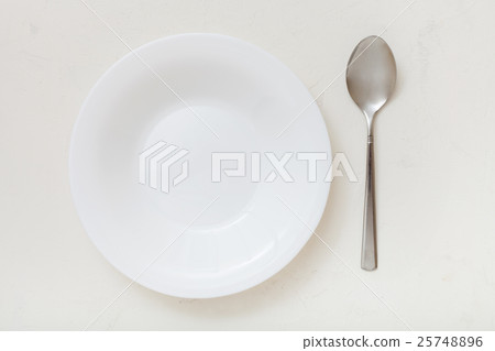top view of white deep plate and spoon on plaster top view of white deep plate and spoon on plaster 25748896