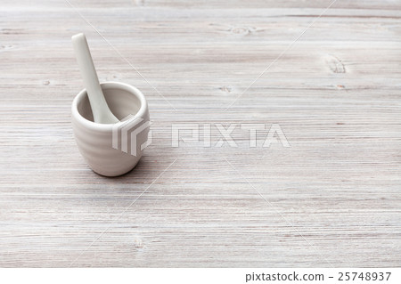 cup for sake with spoon on gray brown wooden table 25748937