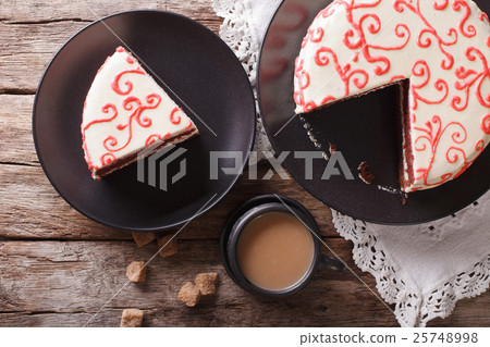 Sliced festive red velvet cake and coffee close-up 25748998