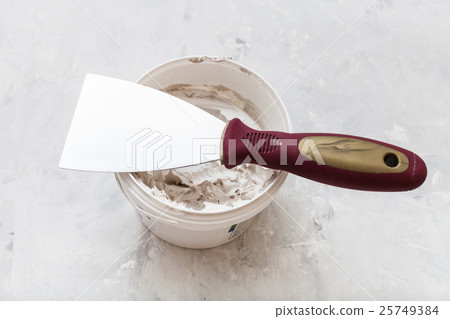 metal spatula on tube with putty metal spatula on tube with putty 25749384