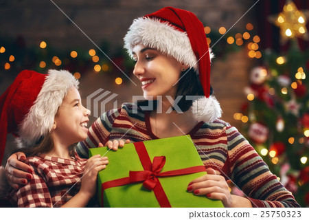 Mother and daughter exchanging gifts Mother and daughter exchanging gifts 25750323