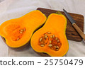 Squash cut in half on a wooden board 25750479