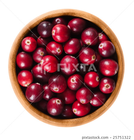Fresh cranberries in wooden bowl over white Fresh cranberries in wooden bowl over white 25751322