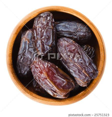 Dried Medjool dates from Morocco in wooden bowl Dried Medjool dates from Morocco in wooden bowl 25751323