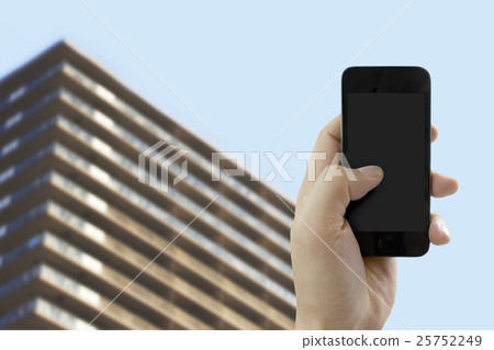 Image using smartphone in front of apartment Image using smartphone in front of apartment 25752249
