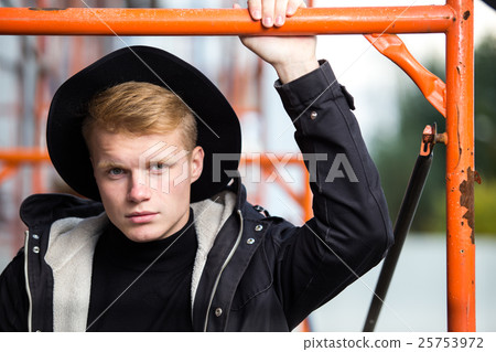 Young man posing with a trendy outfit against 25753972