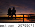 silhouette man and woman sitting on the iron bar 25755075
