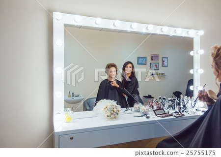 Make up artist doing professional makeup of young Make up artist doing professional makeup of young 25755175