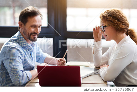 Middle-aged couple working on laptop and taking 25756067