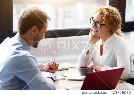 Middle-aged couple working on laptop and taking Middle-aged couple working on laptop and taking 25756070
