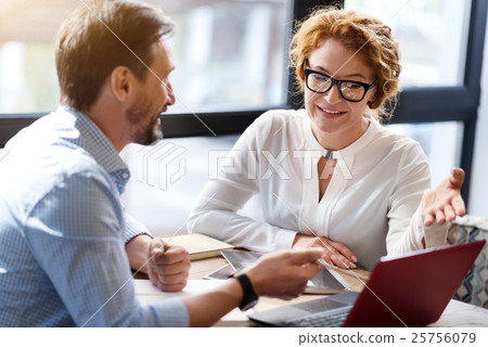 Middle-aged man and woman discussing information Middle-aged man and woman discussing information 25756079