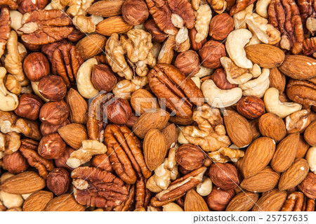 Mix of different nuts closeup photo 25757635