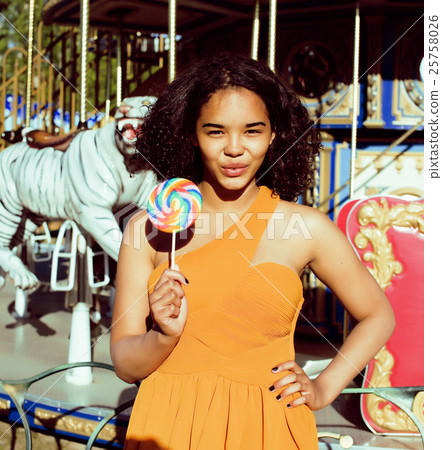 cool real teenage girl with candy near carousels 25758026