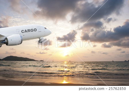 Cargo airplane taking off at sunset on the beach 25762850