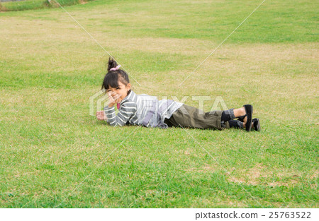 Girls lying on lawn Girls lying on lawn 25763522