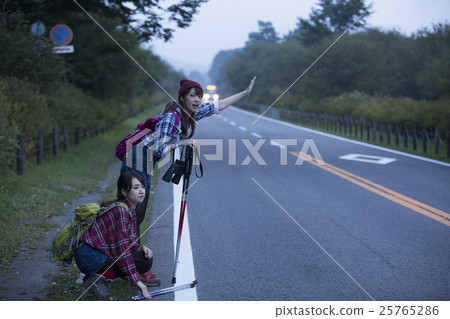 A woman hitchhiking 25765286