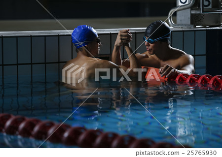 Swimming players who are pleased with each other Swimming players who are pleased with each other 25765930
