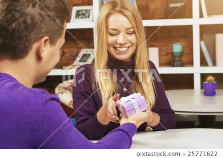 Young man making a gift to the girl 25771622