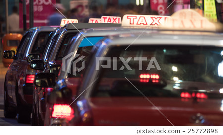Taxi cars parked in row at night Taxi cars parked in row at night 25772898