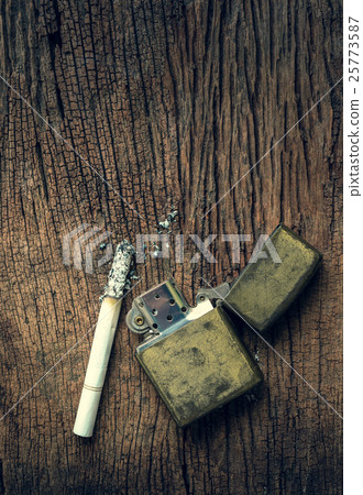 cigarette and lighters placed on the wooden floor.  25773587