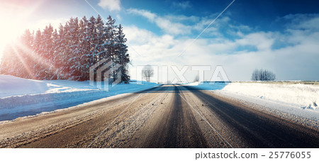 Asphalt road in snowy winter on beautiful sunny 25776055