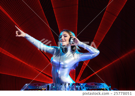 Stock Photo: DJ girl on decks at the party