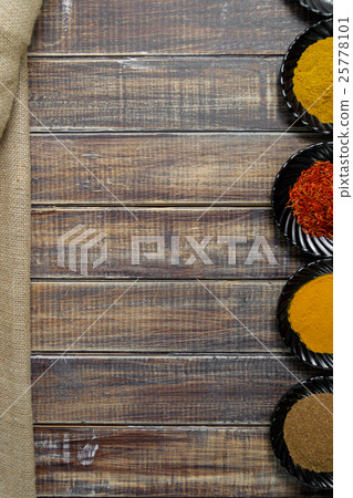 Spices in black ceramic plates on wooden Spices in black ceramic plates on wooden 25778101