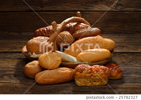 Variety of bread on old wooden background. Variety of bread on old wooden background. 25782327
