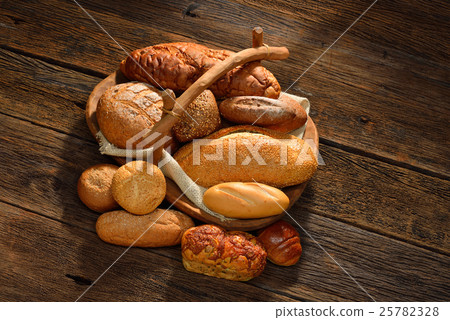 Variety of bread on old wooden background. Variety of bread on old wooden background. 25782328