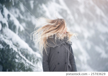 Beautiful young woman on a walk in winter nature Beautiful young woman on a walk in winter nature 25783629