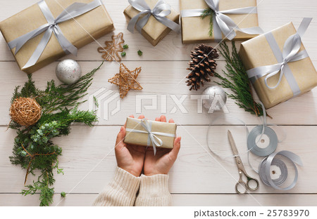 Gift wrapping. Packaging modern christmas present Gift wrapping. Packaging modern christmas present 25783970