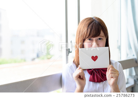 High school student with a love letter in the classroom window High school student with a love letter in the classroom window 25786273