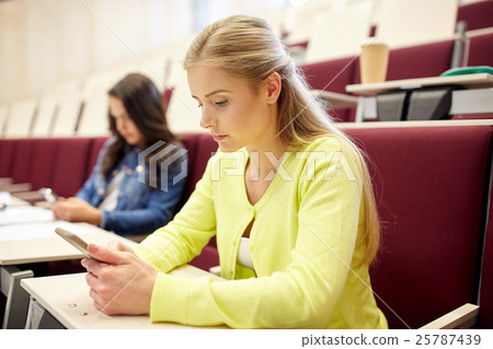 student girls with smartphones on lecture 25787439
