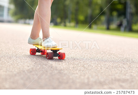 close up of female feet riding short skateboard close up of female feet riding short skateboard 25787473