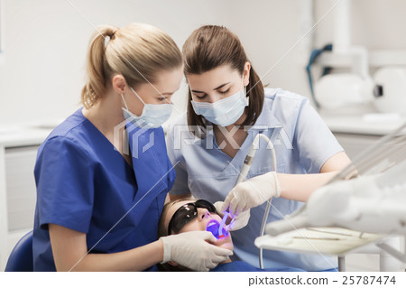 female dentists treating patient girl teeth female dentists treating patient girl teeth 25787474