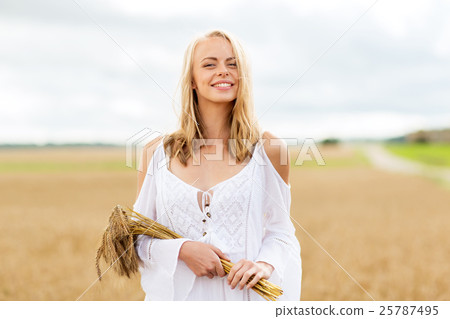 happy young woman with spikelets on cereal field 25787495
