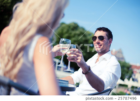 couple drinking wine in cafe 25787496