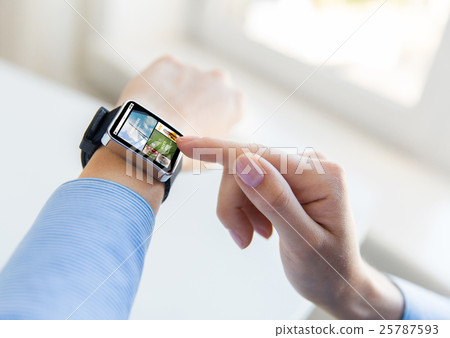 close up of female hands with news on smart watch close up of female hands with news on smart watch 25787593