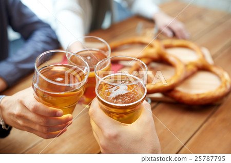 close up of hands clinking beer at bar or pub close up of hands clinking beer at bar or pub 25787795