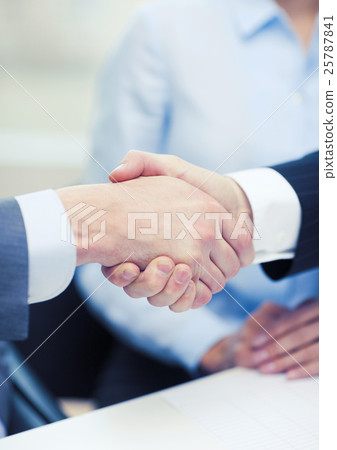 two businessmen shaking hands in office two businessmen shaking hands in office 25787841