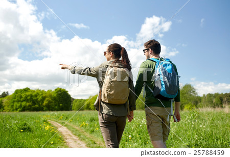 happy couple with backpacks hiking outdoors happy couple with backpacks hiking outdoors 25788459