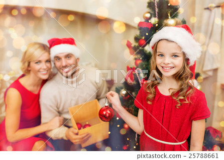 smiling family decorating christmas tree 25788661
