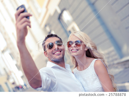 smiling couple with smartphone in the city smiling couple with smartphone in the city 25788878