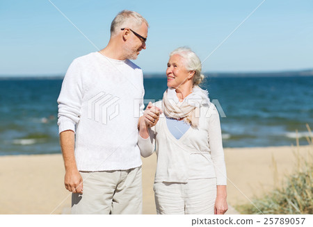 happy senior couple holding hands on summer beach happy senior couple holding hands on summer beach 25789057