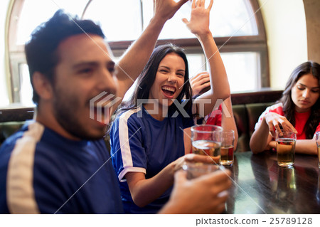 football fans with beer celebrating victory at bar 25789128