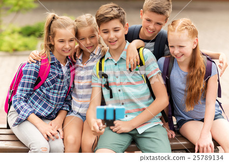 happy elementary school students taking selfie 25789134