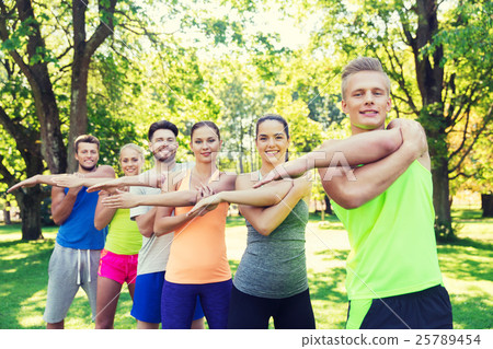 group of friends or sportsmen exercising outdoors group of friends or sportsmen exercising outdoors 25789454