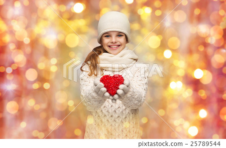 girl in winter clothes with small red heart girl in winter clothes with small red heart 25789544