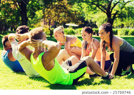 group of friends or sportsmen exercising outdoors 25789746